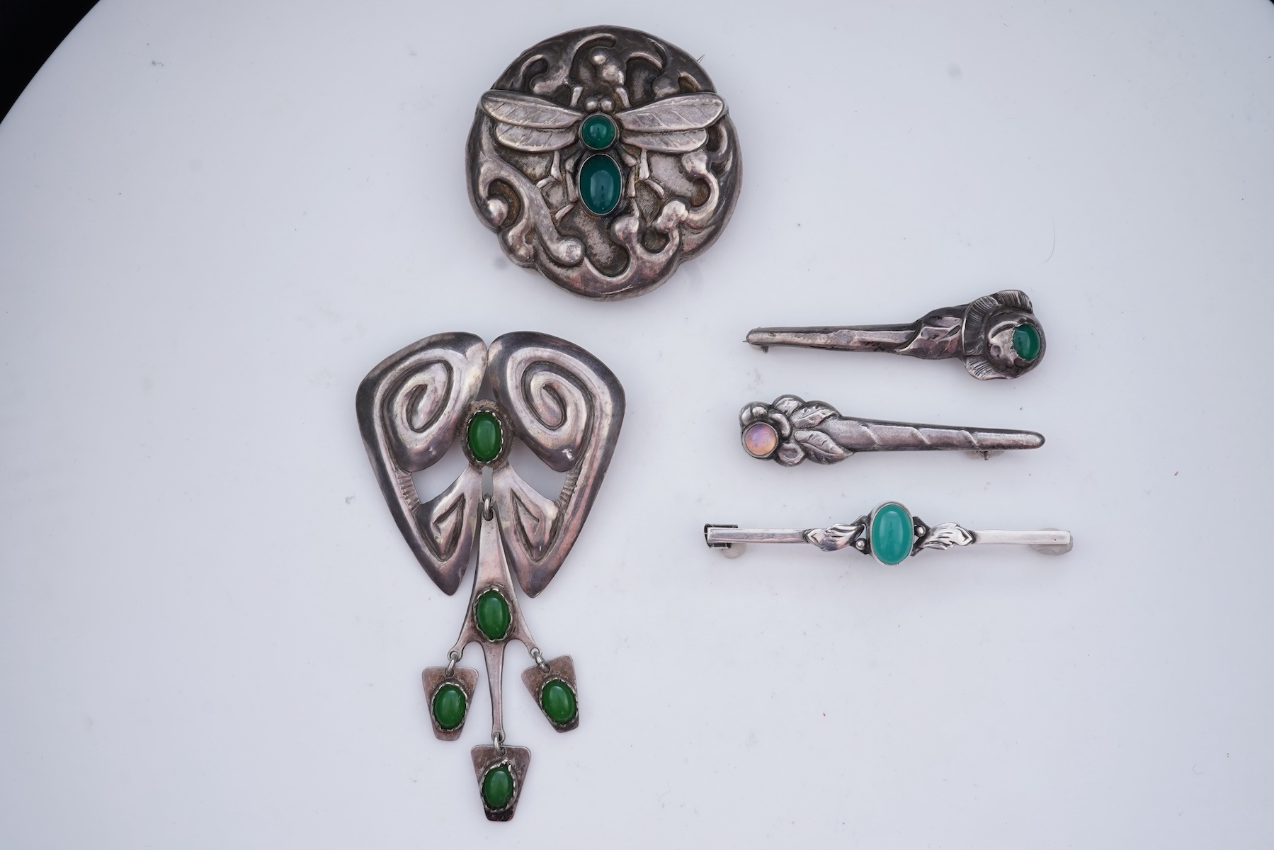 A collection of five Arts & Crafts silver brooches, Denmark, early-mid 20th century